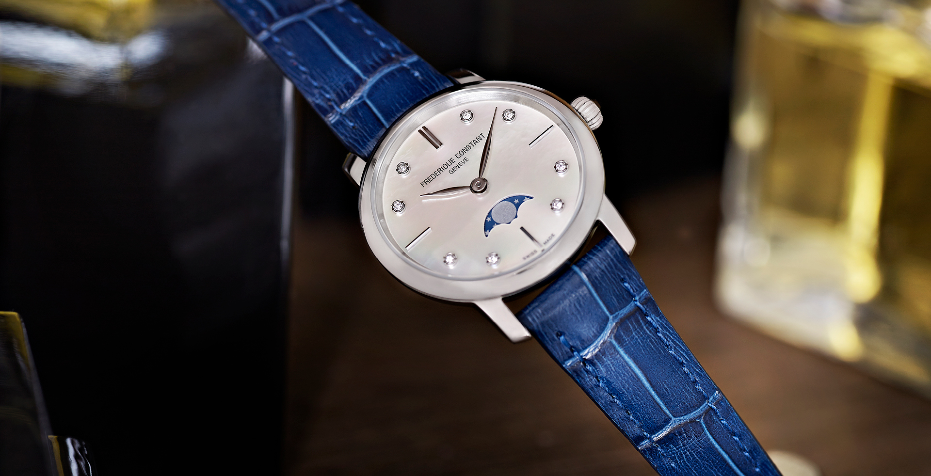 Slimline Ladies Moonphase watch for woman. Quartz movement, white mother of pearl dial with 8 diamonds, stainless-steel case, moonphase and blue leather strap 