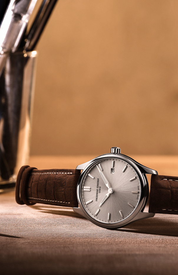 Classics Quartz watch for man. Quartz movement, silver dial, stainless-steel case, date window and brown leather strap 