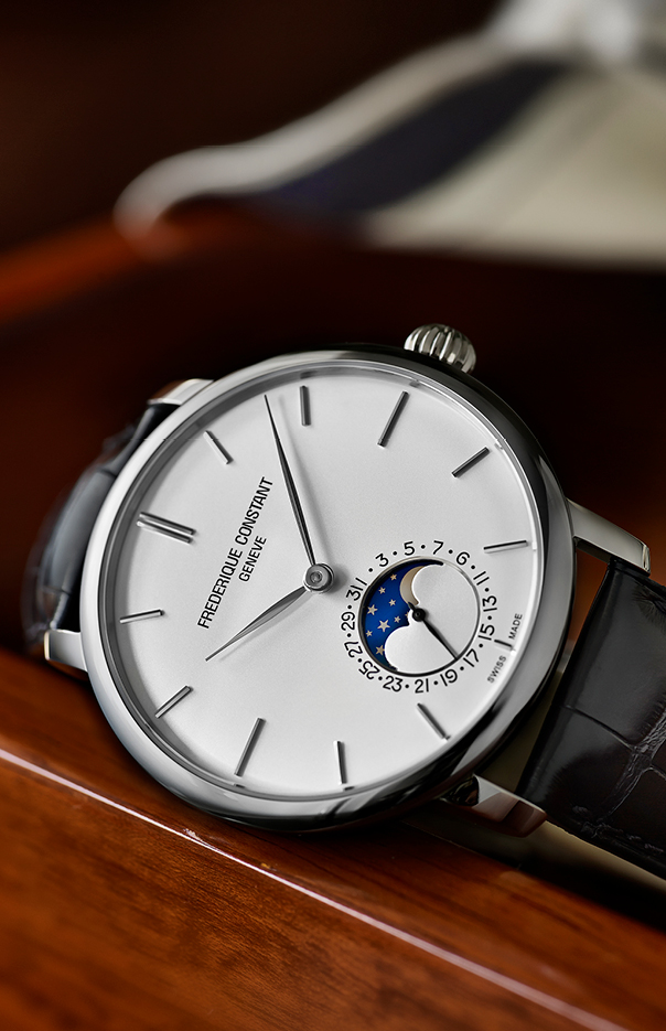 Constant Slimline Moonphase Manufacture watch for man.   Automatic movement, white dial, stainless-steel case, date counter, moonphase and black leather strap 