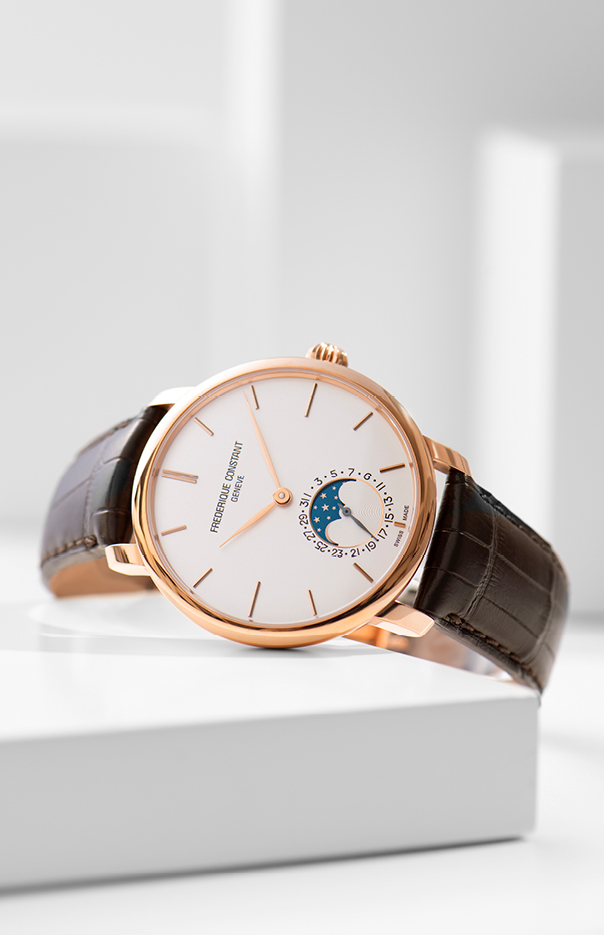 Constant Slimline Moonphase Manufacture watch for man.   Automatic movement, white dial, rose-gold plated case, date counter, moonphase and brown leather strap 