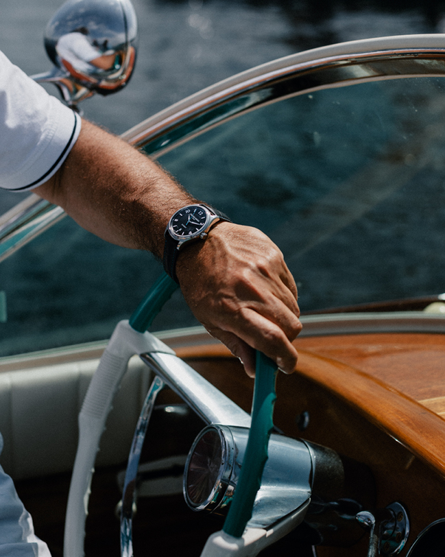 Runabout Automatic watch for man. Automatic movement, black dial with clous de Paris guilloché in the center, stainless-steel case and dark blue-grey leather strap with blue stitching 